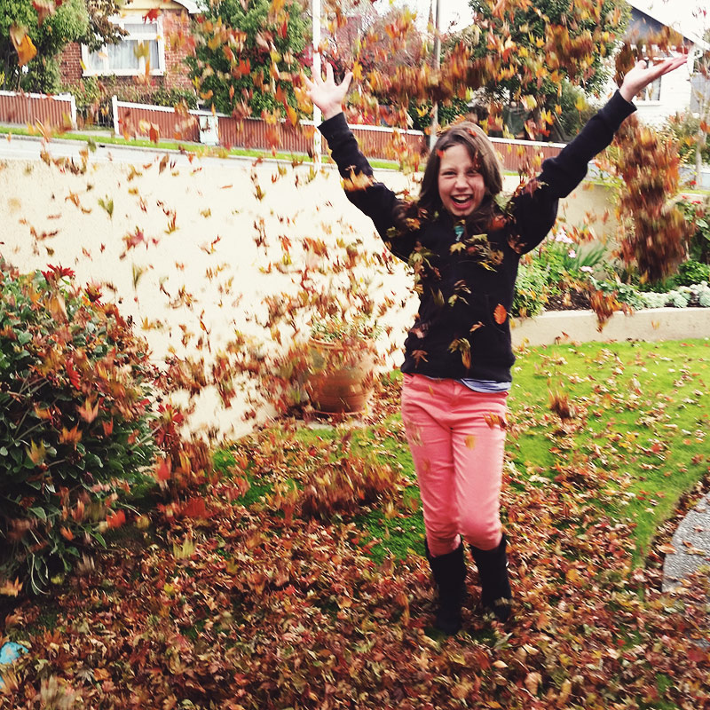 Child throwing leaves